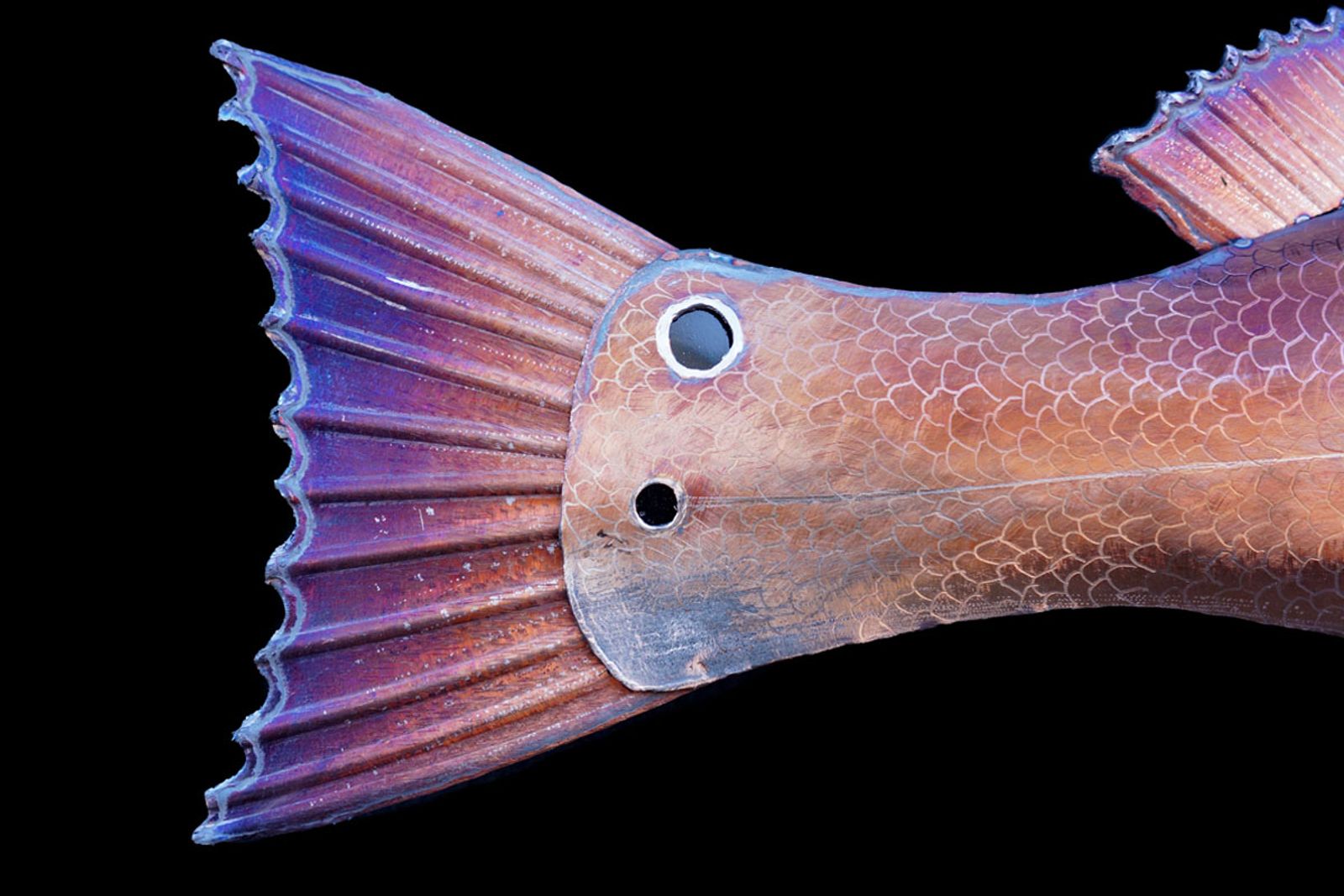 Close up of metal red drum sculptures tail