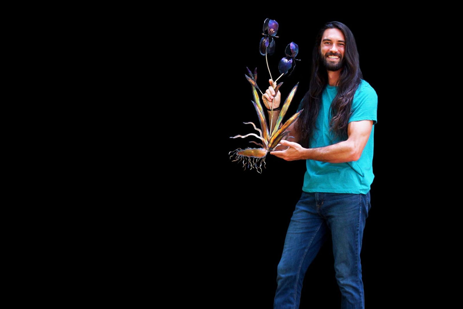 Artist Aiden Dale with metal iris sculpture