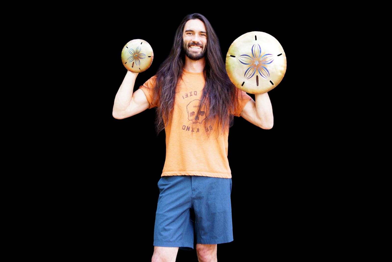 Sculptor Aiden Dale with his sand dollar metal sculptures.