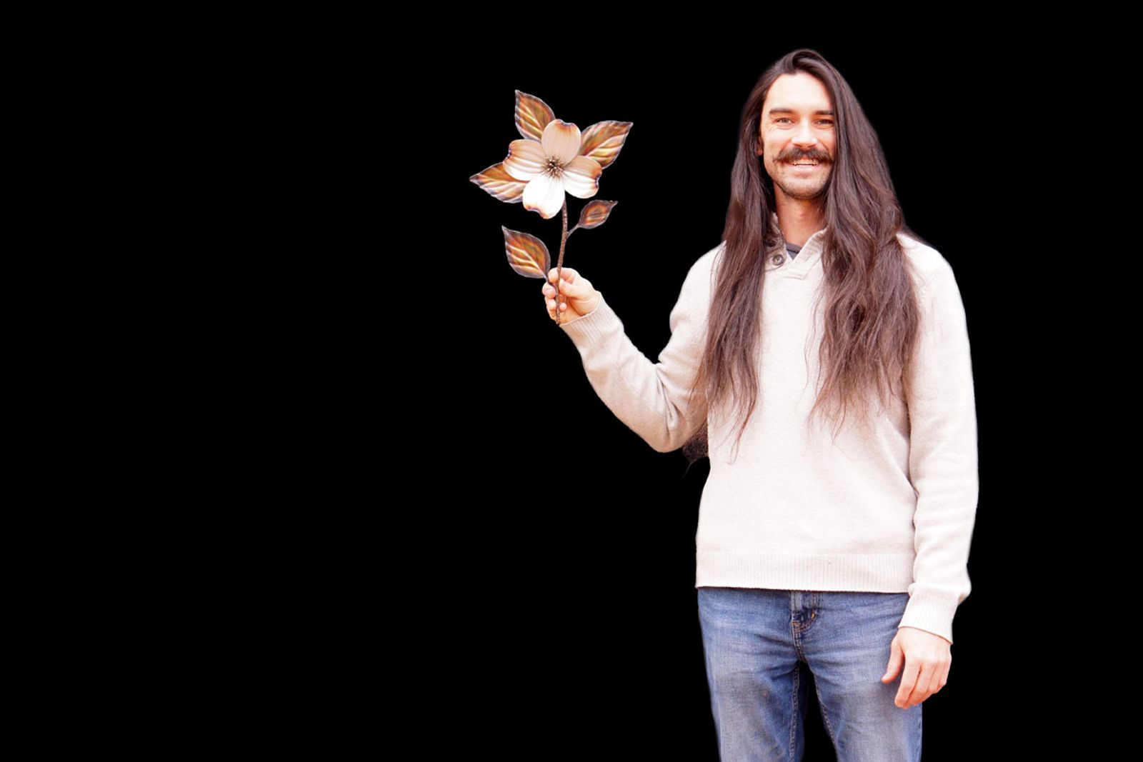 Artist Aiden Dale with his small dogwood branch sculpture.