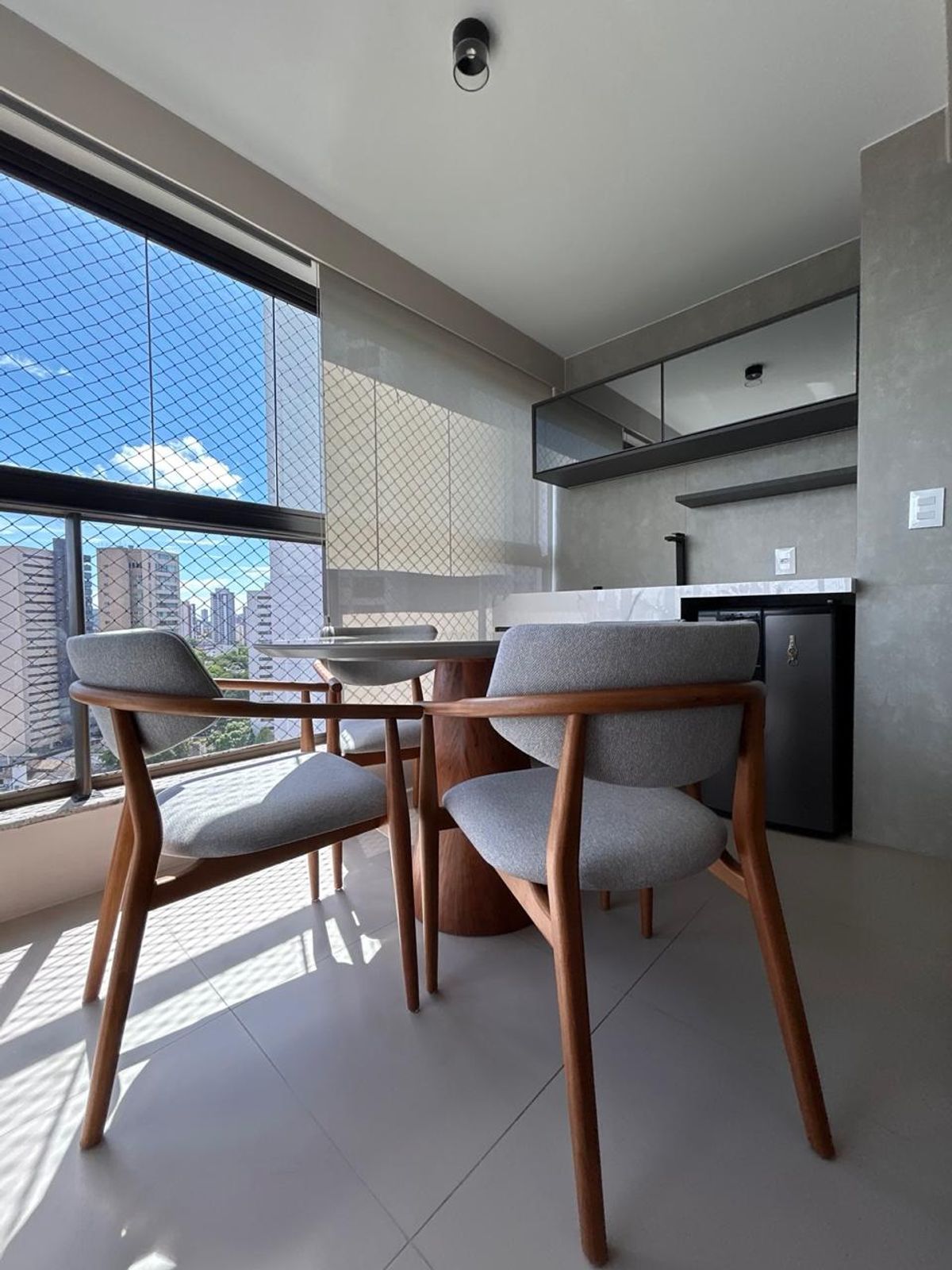 Varanda com poltronas e vista para a cidade
