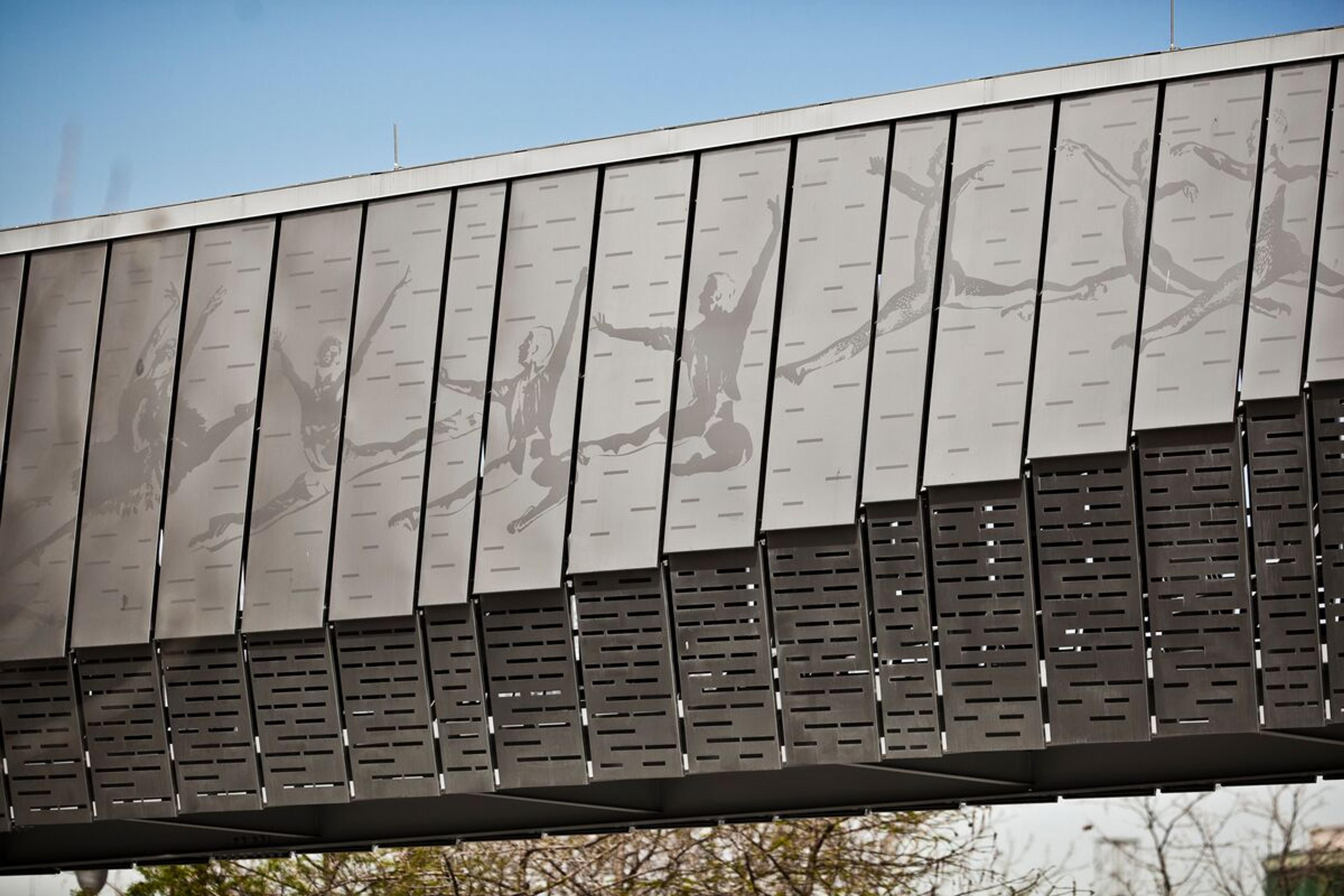 Custom pedestrian bridge in stainless steel • Custom eco-etch patterns bring the design to life • Downtown Houston, Texas