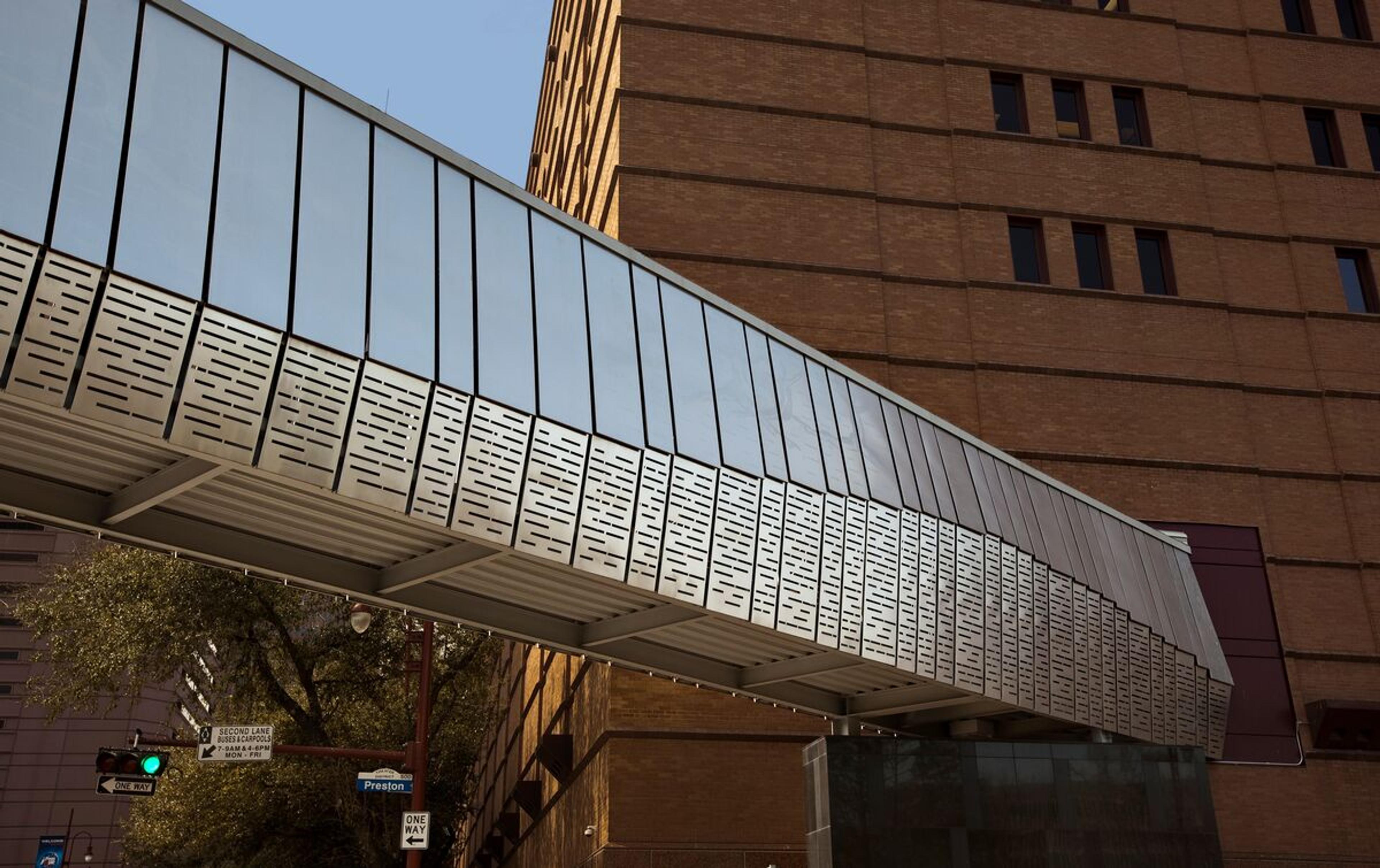 Custom pedestrian bridge in stainless steel • Custom eco-etch patterns bring the design to life • Downtown Houston, Texas