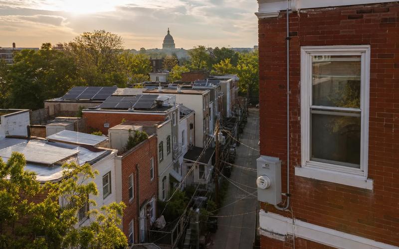 Washington, DC rowhouse rooftops with solar panels visible, illustrating how to choose the best solar installer in DC