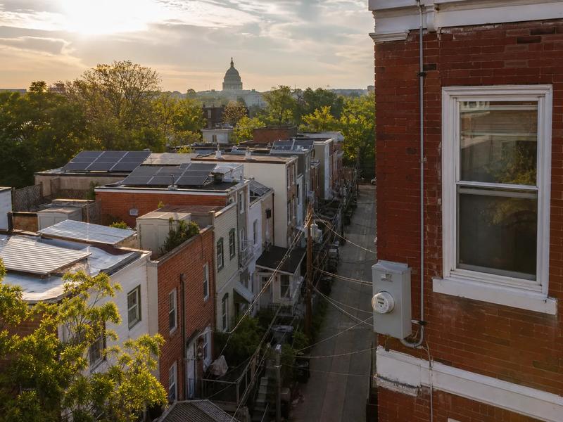 Washington, DC rowhouse rooftops with solar panels visible, illustrating how to choose the best solar installer in DC