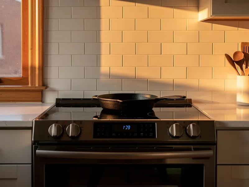 Induction stove installed in a DC rowhouse kitchen with modern cabinetry