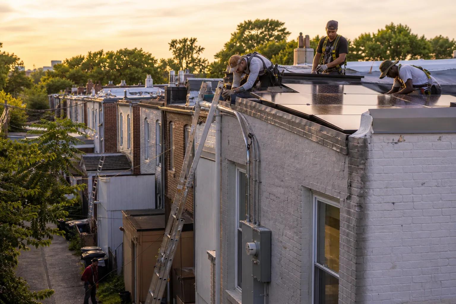 DC solar installers working on a rowhouse rooftop array in Washington, DC with service and monitoring focus