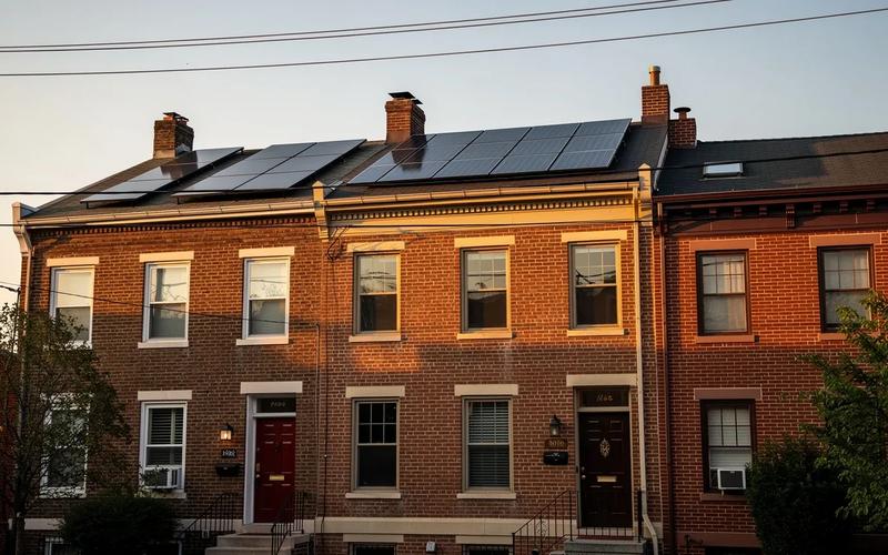 DC rowhouse rooftop solar panels with Pepco utility infrastructure visible in the background