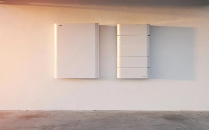 Tesla Powerwall 3 and Enphase IQ Battery 5P mounted side by side in a DC home utility room