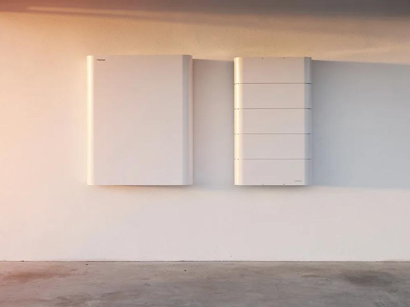 Tesla Powerwall 3 and Enphase IQ Battery 5P mounted side by side in a DC home utility room