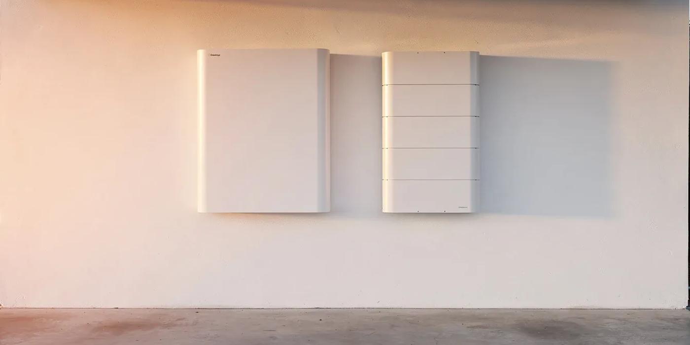 Tesla Powerwall 3 and Enphase IQ Battery 5P mounted side by side in a DC home utility room