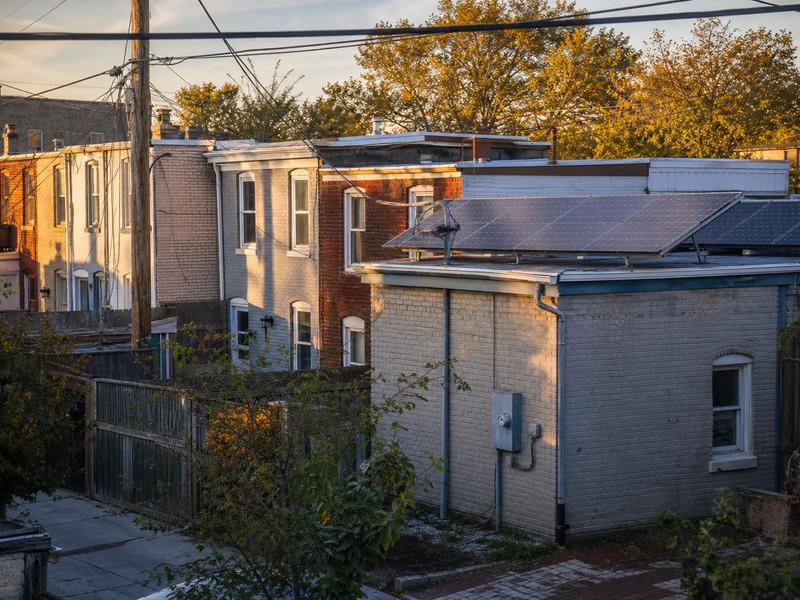 DC rowhouse rooftop with solar panels, illustrating renting solar panels via lease or PPA in Washington, DC