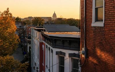 Pepco meter and rooftop solar array in Washington, DC, illustrating policy-stable returns compared to Maine community solar