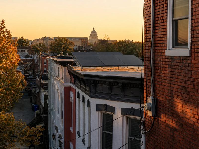 Pepco meter and rooftop solar array in Washington, DC, illustrating policy-stable returns compared to Maine community solar