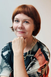 NFSA Chief Curator seated with her hand supporting her chin and smiling.