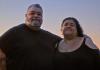 Filmmakers Adrian Russell Wills and Gillian Moody side by side, pictured with a setting sun in the background, in a scene from the film Kindred