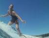 Close up of a woman surfing.