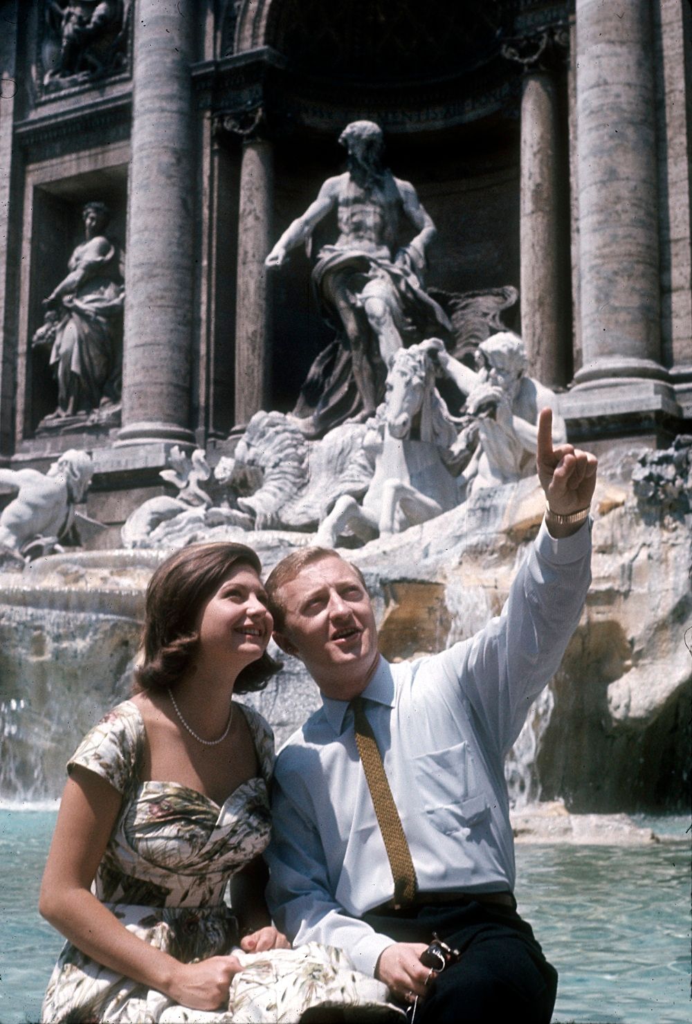 Graham Kennedy with Silvana Alliotti sittingon the edge of the Trevi Fountain, Rome