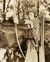 Errol Flynn as Robun Hood sets himself to fire an arrow
