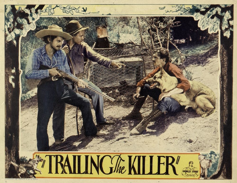Central images features the alsation Caesar resting on the lap of Francis McDonald with two men standing, one holding a gun.