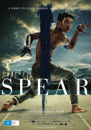 Poster of a film titled ‘Spear’ showing a person in a dynamic pose with blue paint on the body, city skyline in background.