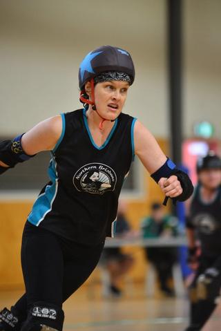 Phoebe Hart playing roller derby