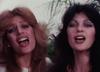 Close up of two women singing.