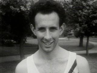 Man in athletic singlet directly facing camera