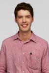 A portrait of a man in a collared shirt. He has a pen in his pocket.