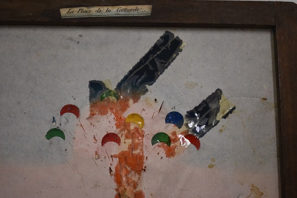 Reverse side of a Polyorama Panoptique slide showing coloured crescent slashes added to produce an optical effect