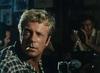 Jack Thompson as Joe turns to look past the camera with a cigarette in the corner of his mouth