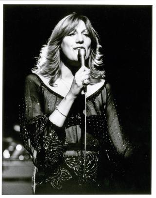 Singer Renee Geyer in a studio singing into a microphone.