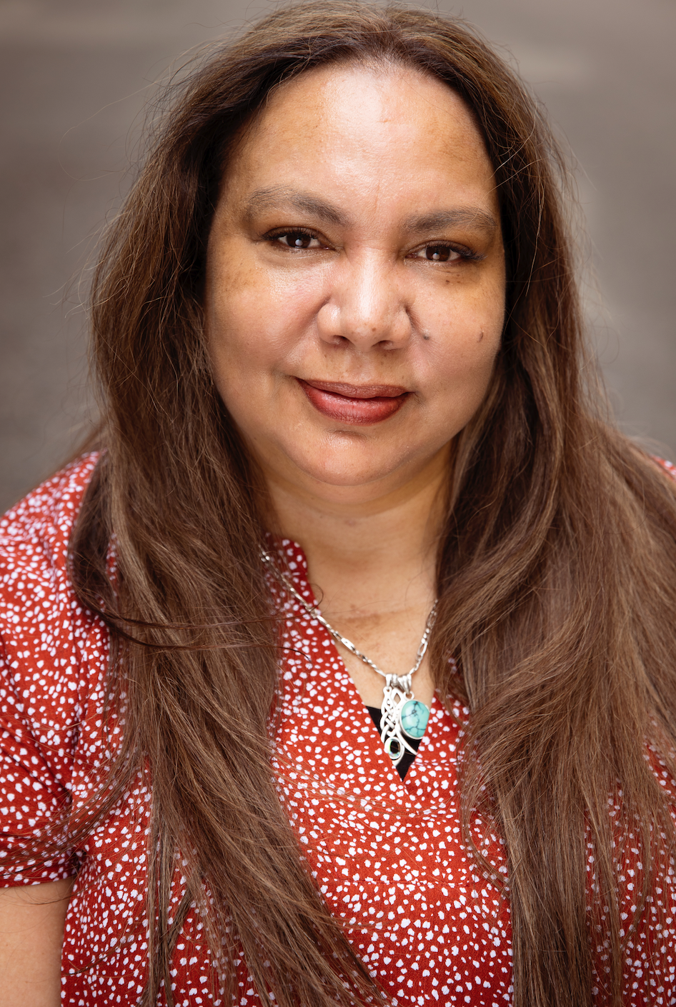 Head and shoulders shot of a First Nations Head Pauline Clague smiling at camera
