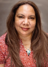 Head and shoulders shot of a First Nations Head Pauline Clague smiling at camera