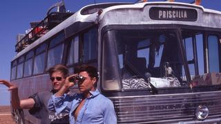 Director Stephan Elliot and Guy Pearce look out across the stony gibber desert with the bus in the background.
