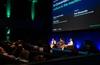 Peter-Lucas Jones, Kathy Reid and Keir Winesmith presenting a panel on a stage