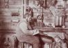 Wireless operator seated at his desk wearing headphones
