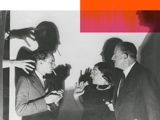 Peter Finch standing with a young woman and older man in profile. There are some menacing shadows behind them and the woman looks frightened.