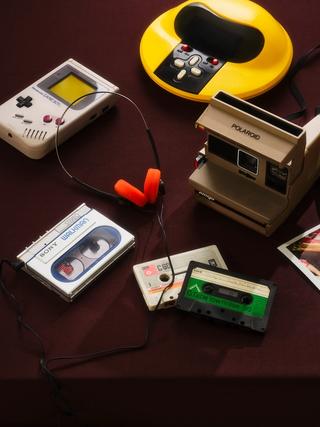 Collection items including Walkman, cassette tapes, headphones and video game consoles