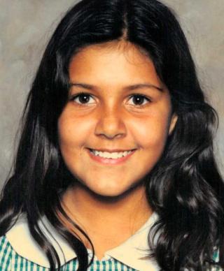 Head and shoulders shot of a young First nations girl in a school photo.
