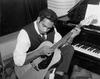Jimmy Little playing a guitar