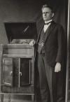 Inventor Stuart Booty in 1925 standing next to a homemade gramophone.