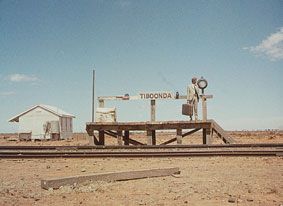 Small, rustic railway platform in a desolate landscape