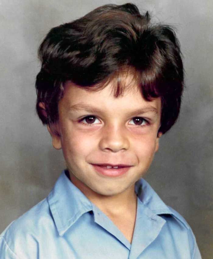 Head and shoulders shot of a young First Nations boy in a school shirt