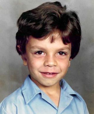 Head and shoulders shot of a young First Nations boy in a school shirt