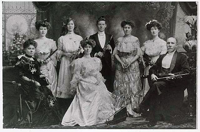 The Corrick family with their musical instruments posing for the camera