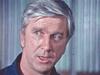 A close-up of Leslie Nielsen, looking away from the camera