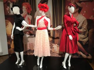 Three dresses from the film The Dressmaker on exhibition display.