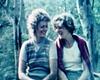 Two women sitting next to each other smiling