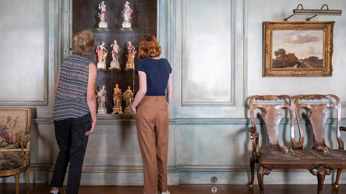 Visitors admiring the display of Apollo and the Nine Muses, Chelsea Porcelain Factory (1744-1769) at Upton House, Warwickshire